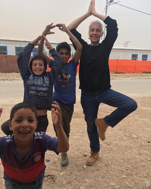 The boys are full of super nature - in each,seemingly the energy of 5 others.
Minutes before the storm came in they ran towards us & spontaneously picked up where we had left off with our impromptu street yoga of last year - blown off balance only by blasting pulses of wind & sand, they were just as determined to see the images taken - through sign language asking for real copies, which I will bring back for sure next time.
On the edge of themselves & the camp,realising too, that in Za’atari there are very few places to see ones self reflected back - very few mirrors, shiny car,or shop windows,  all those urban surfaces we glimpse & that remind us of knowing how we appear to others, knowing we are here. 
Instead, there is an intensity of relating, where it is the eyes of the other that reaffirms connection, personalities seem more distinct, loudly, or quietly themselves, the absence of the once removed image heightens what it means to be yourself here.
And as I